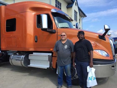 Leon Bell, left, and Edward Carpenter, right, attended the driver appreciation event together. Bell is Carpenter's trainer, and Carpenter is expected to graduate to his own truck this month.