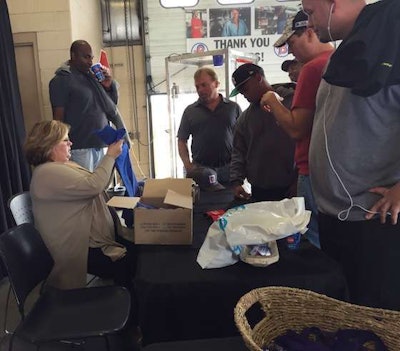 Lori Furnell, seated, had drivers draw for prizes. Prizes included free shirts, hats, gift cards, a CB radio, and more.