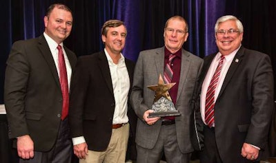 Gary Plant, second from right, a professional truck driver with Walmart Transportation, was named National Driver of the Year by the American Trucking Associations. With him are, left to right, Jason Wing, director of fleet safety at Walmart Transportation, Mike Noble, senior director of fleet safety at Walmart Transportation, and Dennis Shinault, director of Loss Prevention and Safety Services, Baldwin & Lyons: Protective Insurance. (ATA photo)