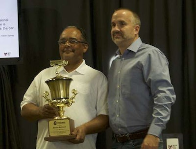 Kevin Spivey, a Boyd Bros. fleet manager, presents a three million miles trophy to his driver James Redmon.