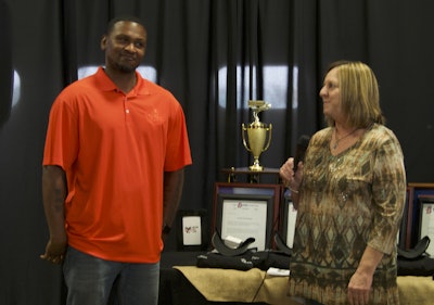 Leon Moore, left, is recognized for reaching one million safe driving miles by his fleet manager, Diane Galloway.