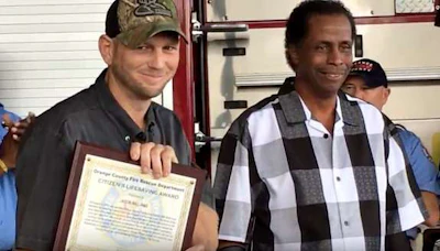 Orange County Fire Rescue presented Jason Williams (left) with the Citizen Lifesaving Award for rescuing Michael J. Bridges (right)