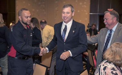 Eric Courville, center, was named Grand Champion at the Louisiana Truck Driving Championships. (Image Courtesy of John Ballance Photography)