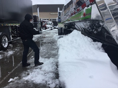 Barry Kasdorf of Winnipeg, Manitoba, Canada cleans his tank trailer