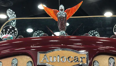 The hood ornament is a chrome angel with orange wings.
