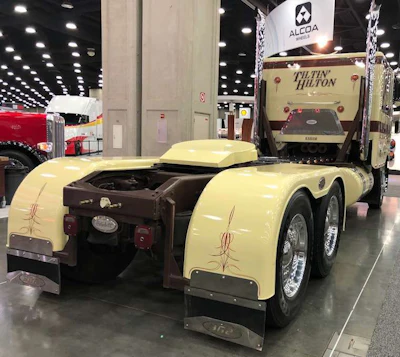 The back of this 1985 Peterbilt Model 362's sleeper reads 'Tiltin' Hilton.'