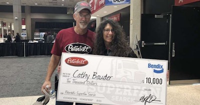 Cathy Bauder, right, and her husband Steve, left, left MATS with a $10,000 check.