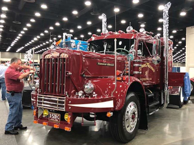 Jerry Howard makes some finishing touches to his 1956 DC-75 Autocar before the Mid-America Trucking Show opened in Louisville on Thursday.