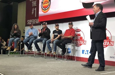 Left to right: Cathy Bauder, Jake Bartos, Josh Hainstock, Sheldon Hyatt, Rick McClerkin and Red Eye Radio host Eric Harley come together on stage at Peterbilt's SuperFan celebration. McClerkin was announced as the SuperFan winner at the end of the event.