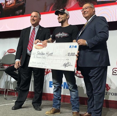 Sheldon Hyatt, center, was presented $10,000 by Peterbilt General Manager Kyle Quinn, left, and Robert Woodall, assistant general manger of sales and marketing, right. Hyatt was one of five finalists in the SuperFan contest.