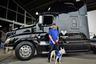 James Rogers was gifted a black remodeled 2015 Freightliner Cascadia. His purebred American Staffordshire Terrier is named Sergeant. Sergeant travels over the road with Rogers. (Image Courtesy of Progressive Commercial/Allison+Partners)