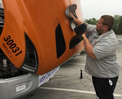 Branden Toomey polishes one of the several trucks A. Duie Pyle had in Sunday’s convoy