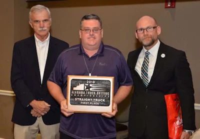 FedEx Freight's David Hawk, center, won first place in the Straight Truck class. (Image Courtesy of Alabama Trucking Association/Facebook)