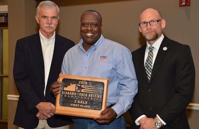 YRC Freight's Alphonso Lewis, center, won first place in the 3-Axle class. (Image Courtesy of Alabama Trucking Association/Facebook)