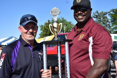 FedEx Freight driver Todd Flippin, left, was named grand champion at the Colorado TDC. Port Officer Alex Washington, right, helped present him the trophy. (Image Courtesy of Colorado Motor Carriers Association)