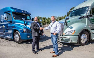 Ron Riddle, CEO of Leavitt’s Freight Service (left) joins Rick Williams, CEO of Central Oregon Truck Company (right) as a member of the Daseke family. (Daseke photo)
