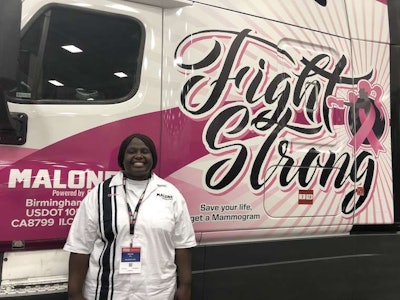CRST Malone surprised truck driver Chanita Ward with a custom breast cancer truck wrap during a ceremony at GATS.
