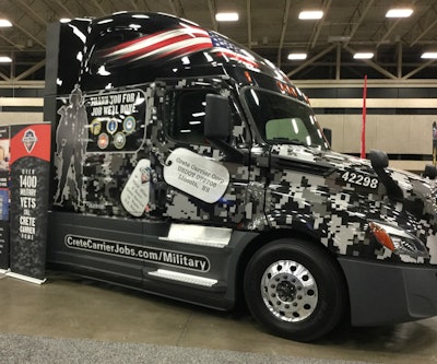 Crete Carriers military-themed wrapped truck at GATS.