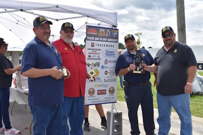 Left to right: McPherson driver Mark Ellsworth, driver/dispatcher Charles Tipton, warehouse manager Allan Naylor, and driver/customer service representative Michael McPherson celebrate the companies involvement in the Alabama convoy for Special Olympics.