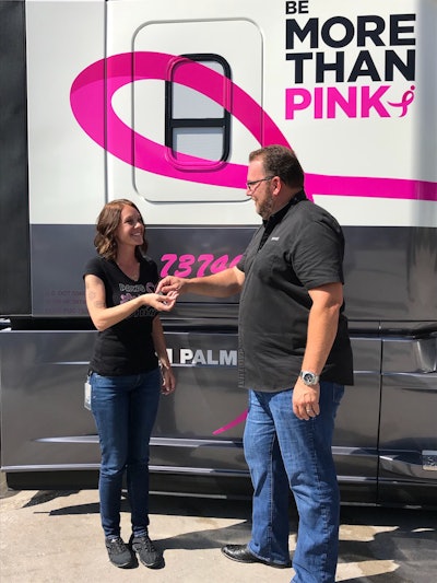 Leathers presents Palmer with the keys to the custom-wrapped 2019 Freightliner Cascadia. (Image Courtesy of Werner Enterprises)