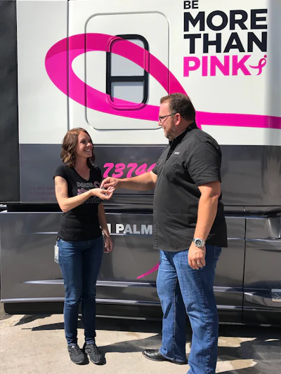 Leathers presents Palmer with the keys to the custom-wrapped 2019 Freightliner Cascadia. (Image Courtesy of Werner Enterprises)