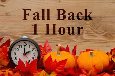 Fall Back 1 Hour message with clock, orange pumpkins, and fall leaves