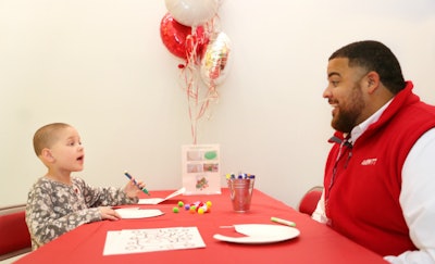 Isaiah Woodard (right), Averitt’s Fort Myers service center director, spends some time doing crafts with a St. Jude Children’s Research Hospital patient during Averitt’s recent visit to the facility. (Averitt photo)