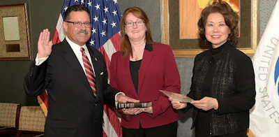 Raymond Martinez, his wife Marin Gibson, and DOT Secretary Elaine Chao (FMCSA photo)