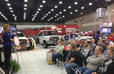 An interested audience learns more about the trucks at the Ford Commercial Truck booth.