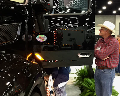 Showgoer admires the new Blackout exterior package fro Peterbilt.
