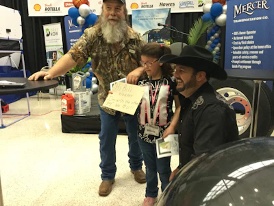 The Mountain Man (left) and Tony Justice (right) pose with a young fan at the Red Eye Radio booth at MATS.