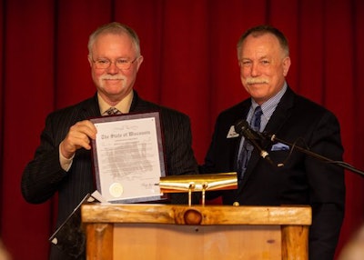 Wisconsin Motor Carriers Association President Neal Kedzie, right, stands with WMCA’s Driver of the Year Douglas Christianson, left, during the association’s annual Safety Awards Banquet. (Image Courtesy of Facebook/Sparhawk Trucking)