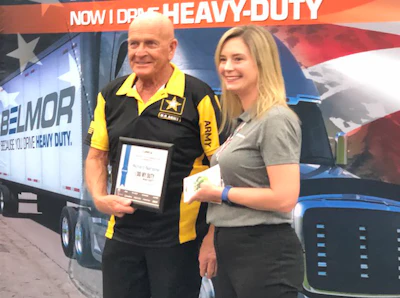 Richard Nardone, left, receives an award certificate from Lauren Lambrix, Lund International’s marketing and truck show specialist.