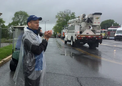 Ben Lee, regional director for Make-A-Wish, cheers on truckers as the convoy begins.