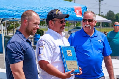 Walmart Transportation driver Robert Benton, center, receives the Delaware grand champion award. (Image Courtesy of Delaware Motor Transport Association)