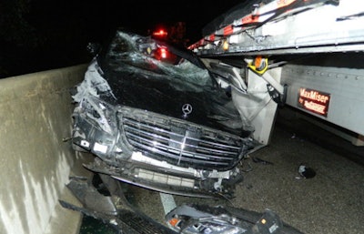 The 2014 Mercedes driven by Armajeet Luthra, 72, of Louisville, Kentucky trapped between a highway barrier and trailer on I-65. (Indiana State Police photo)