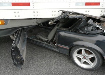 A Mustang crashed underneath a semi and travel half a mile underneath it before the truck came to a stop. (Image Courtesy of Indiana State Police)