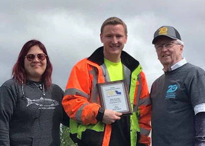Sourdough Express driver Jesse Walker, center, won first place in Alaska's flatbed class. (Image Courtesy of Alaska Trucking Association/Facebook)
