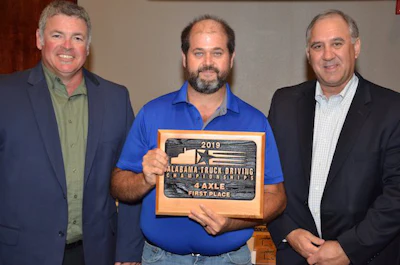 TDC Event Chairman Jeff Melville of Publix, left, and Alabama Trucking Association Chairman Fenn Church, right, present FedEx Freight driver Cecil Salter, center, with the first place award for Alabama's 4-axle class. (Image Courtesy of Alabama Trucking Association/Facebook)