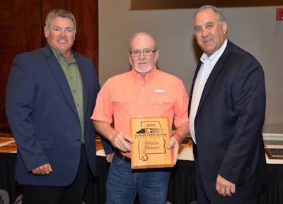 AAA Cooper Transportation driver Philip Arther, center, won the award for having Alabama's highest pre-trip score. (Image Courtesy of Alabama Trucking Association/Facebook)