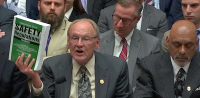 Todd Spencer, president of the Owner-Operator Independent Drivers Association, brandishes trucking’s rule book at House hearing.