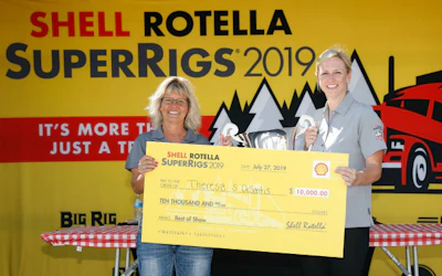 Theresa S. DeSantis (L) accepts the Best of Show trophy at the 37th Shell Rotella SuperRigs awards presentation from Annie Peter, North American marketing manager, Shell Rotella.