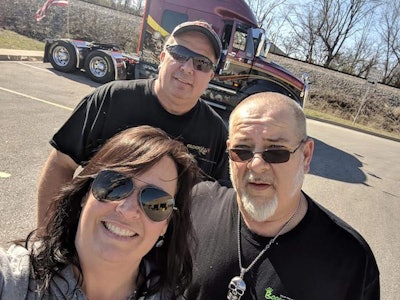 Company drivers Scott Wagner and Robert Barnette didn’t hesitate to lend Shannon Currier a helping hand. (Image Courtesy of Truckload Carrier Association)