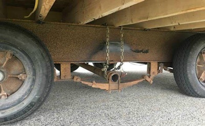 Driver chained an axle missing a wheel to the frame of his trailer.
