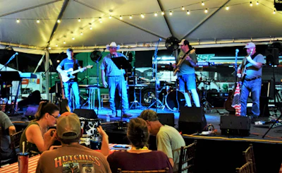 Part of the draw to the parking lot community last year was the Stone Creek Four band, here shown backing Heniff Transportation driver and singer Brad James. They are set to return for 2019’s show.