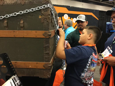 Jaxon Lopez of Tivoli, Texas tries his luck opening the lock on the prize chest at Gorilla Safety Fleet Management booth