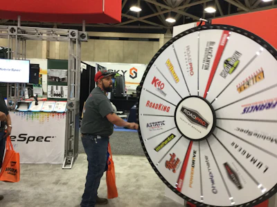 Matthew Smith of Bloomfield, New Mexico spins the prize wheel at the RoadPro booth