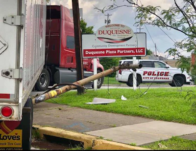 A telephone pole is wedged beneath a truck in Duquesne, Pennsylvania, after an allegedly intoxicated driver attempted a right turn. (Image Courtesy of City of Duquesne Police Department)
