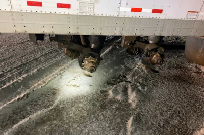 Police in Canada stopped a trucker for driving while missing wheels on their trailer. (Corman Park Police photos)