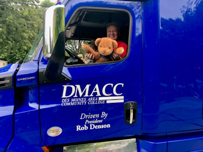 DMACC President Rob Denson and the college mascot in one of the many parades he drives in each summer. (DMCAA photo)